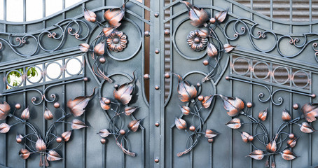 Decoration of metal doors with forged elements