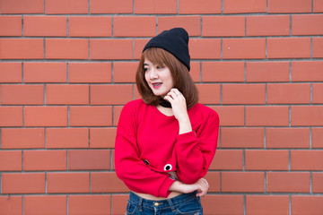 Portrait of beautiful asian chic girl wear black dress pose for take a picture on brick wall,Lifestyle of teen thailand people,Modern woman happy concept