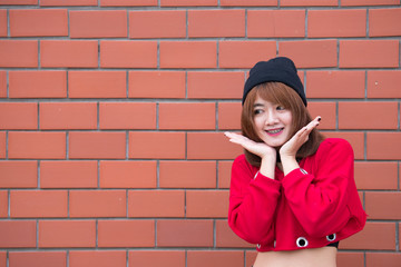 Portrait of beautiful asian chic girl wear black dress pose for take a picture on brick wall,Lifestyle of teen thailand people,Modern woman happy concept