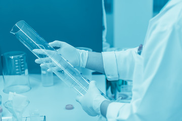 Scientist mix chemicals with The shake machine Before the experiment.Mixture laced with samples into test tubes,Thailand scientist working in the lab