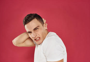 man with a headache on a pink background