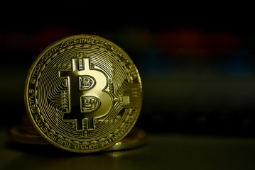 Shiny gold bitcoin on dark background 