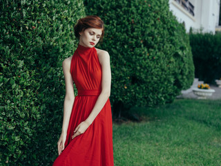 beautiful woman in red dress in the park