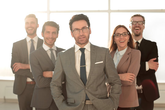 Happy business team with arms crossed at the office