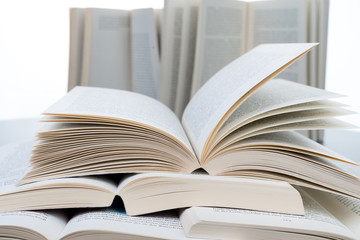 Stack of open books lying on grey table