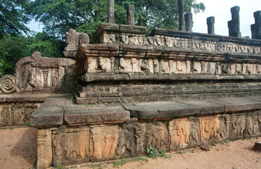 Fototapeta premium Foundations of the palace in ruined city Polonnaruwa with reliefs and columns, Sri Lanka. UNESCO World heritage Site