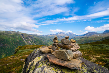 Stacked stones in the mountains in Norway along the Tindevegen
