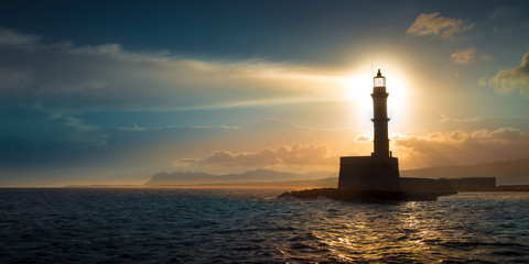 A beautiful night sky behind a shining lighthouse. Chania, Crete, Greece