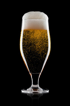 Cold glass of lager beer with foam and bubbles