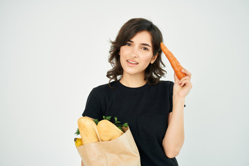 woman holds a grocery bag in her hand