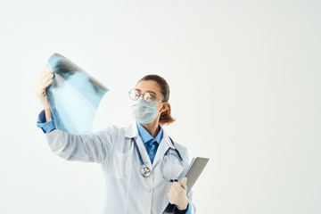 woman in lab coat looking x-ray