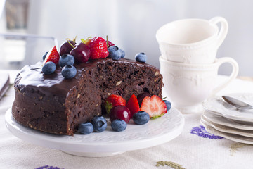 chocolate cake with fresh berries, on white background.Sweet dessert. Copy space.
