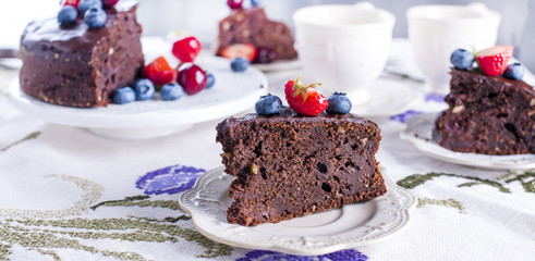 chocolate cake with fresh berries, on white background.Sweet dessert. Copy space.