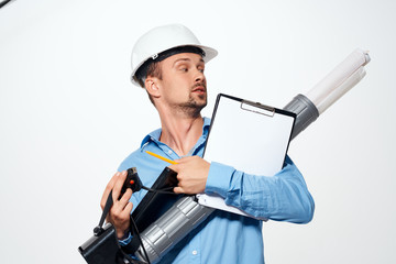 builder in a white helmet with drawings