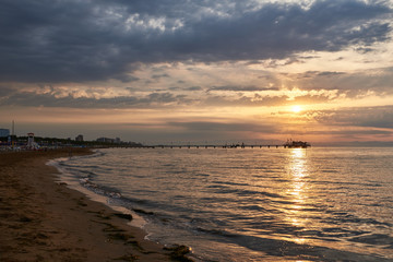 Amazing Sunset on the Sea. Adriatic sea with shore. Lignano Sabbiadoro, Italy. 