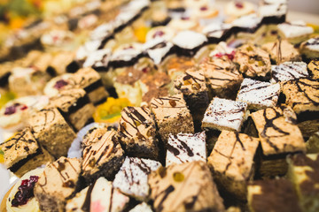 Delicious sweets on wedding candy buffet with desserts, cupcakes