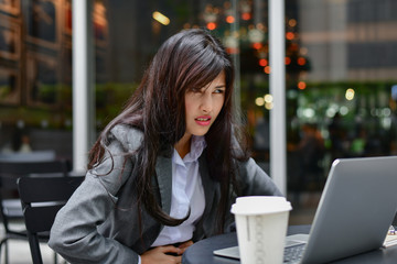 Business Concept. Young businessmen are feeling bad. Young businesswoman is sick. Asian business...