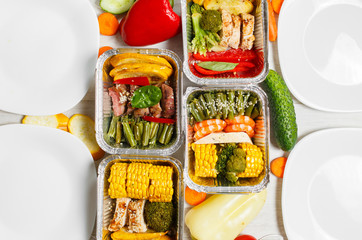 Healthy meal prep containers with vegetables, chicken, beef and shrimp grilled. Close-up, view top.	
