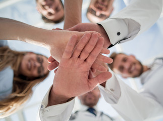 Portrait of a doctor team connecting hands stacking