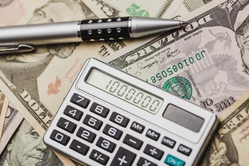 Close-up of Money and Calculator with One Million on the Display