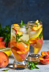 Ice tea with peach and lemon. Cold summer drink.