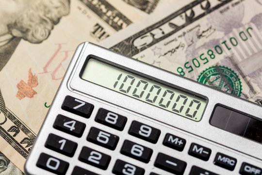 Close-up of Money and Calculator with One Million on the Display