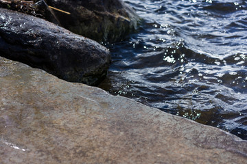 stone shore close up with water