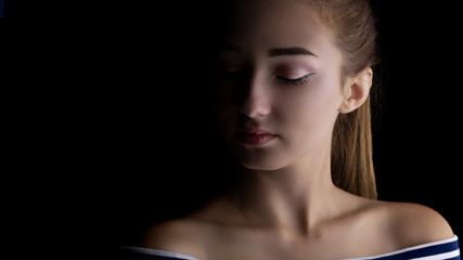 portrait of a girl with makeup on a black background