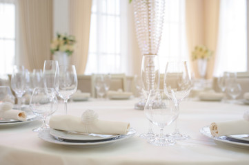 The banquet hall with round tables, with cutlery