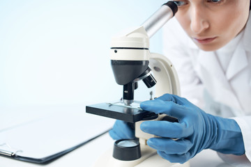 scientist looking through microscope