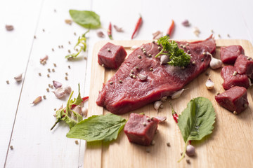 Raw beef on white wood background