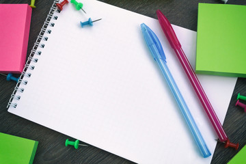 White blank notepad with space for your text, beside stationery. Back to school