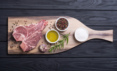 Raw beef steak T bone with ingredient