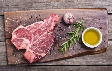 Raw beef steak T bone with ingredient