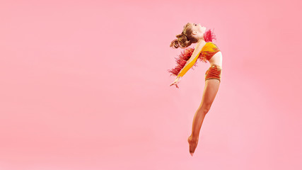 Contemporary dance. A little girl performs a complex acrobatic dance. Modern dance on a bright...