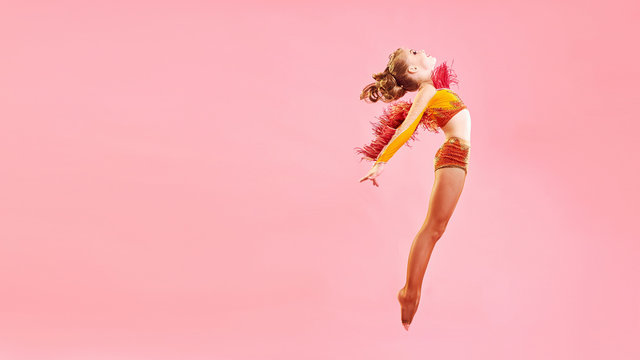 Contemporary dance. A little girl performs a complex acrobatic dance. Modern dance on a bright colorful background.