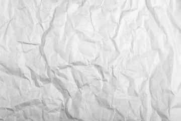 highly crumpled gray paper sheet with dents Close up