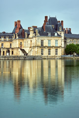 Pond and buildings of Fontainebleau Palace in France.