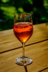 A glass of aperol spritz on a wooden table