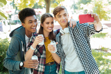 Selfie together. Modern beaming students feeling memorable while making selfie together