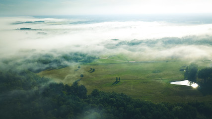 Misty sunrise over countryside path Aerial view Latvia