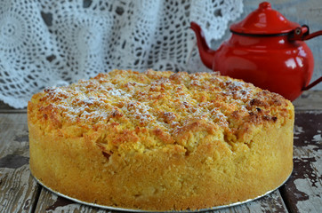Traditional Polish apple pie with crumble on a wooden background