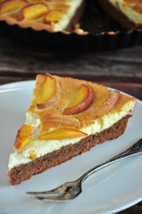 A piece of tarte peaches on a white plate