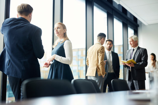 Business People Sharing Expressions After Lecture In Conference Room, Large Group Of Forum Participants Talking During Break