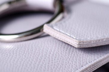 Gray leather bag fittings macro texture on blur background