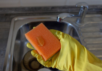 Washing dishes with hands and a washcloth