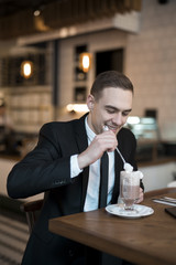 Smiling businessman drink coffe