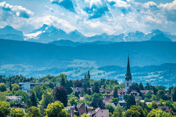 Fototapeta na wymiar Distant view of the city of Zoolikon from the wine terraces of Weinegg district of the city of , Zurich, Switzerland