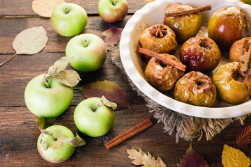 Baked Apples on a Wooden Background Cinnamon Anise and Autumn Leaves