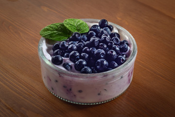 Delicious blueberry on white yogurt with  fresh mint leaves. Amazingly refreshing summer dessert. 